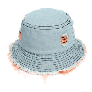 Detailed view of light blue denim bucket hat featuring orange distressed fringe and holes