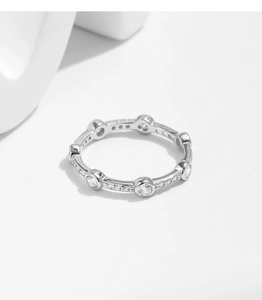 Macro detail of silver S925 eternity ring with sparkling round cubic zirconia stones