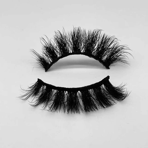 Macro detail of thick and curly black faux mink eyelashes with a durable band