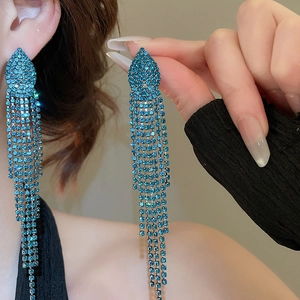 Detailed view of long jellyfish tassel earrings featuring sparkling blue rhinestones