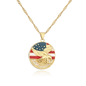Macro detail of gold-plated eagle pendant with US flag enamel and cubic zirconia accents