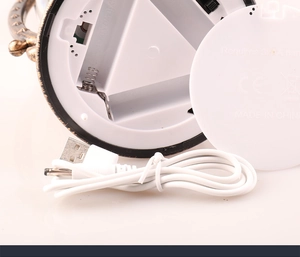 Detail of Christmas lantern base with battery compartment and white USB charging cable