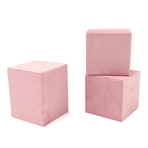 Pink velvet cube jewelry display blocks for necklaces and pendants on white background