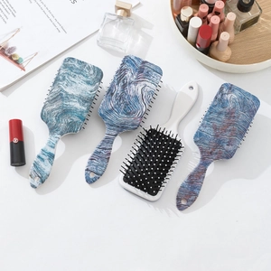 Rectangle hair brushes with marble print and wood texture on a white dressing table