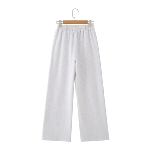 Detail of light gray wide-leg joggers featuring an elastic waistband and soft knit fabric