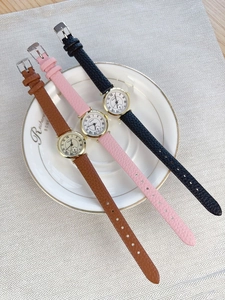 Detailed view of women's vintage quartz watches with Roman numeral dials and leather straps