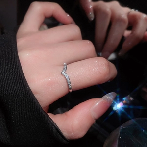 Close-up of elegant V-shaped silver ring with shimmering micro-pave cubic zirconia