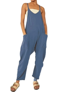 Detail of blue casual jumpsuit showing large front pockets and loose-fit cotton fabric