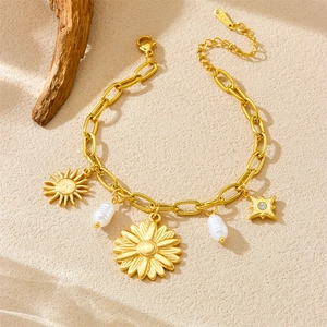 Gold plated stainless steel bracelet with sunflower, sun, star pendants and pearls