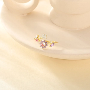 Detail of S925 silver adjustable ring with gold finish and colorful floral gemstone design