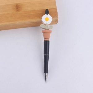 Detailed view of daisy potted plant topper on a black ergonomic creative bead pen