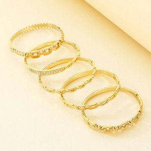 Detailed collection of six 18K gold plated stainless steel bangles with crystal accents
