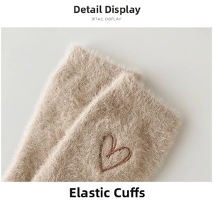 Close-up of elastic ribbed cuff and heart embroidery on plush faux mink fur socks