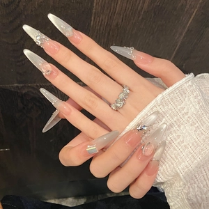 Handmade stiletto press-on nails with white cat eye glitter, pearls, and butterfly charms
