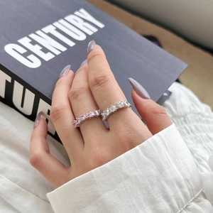 Detail showing S925 silver heart rings with pink and clear zircon stones on fingers