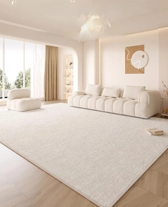 Detail of cream-colored waterproof rug showing short-pile texture and fine edge stitching