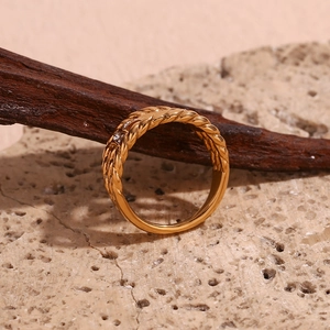 Macro shot of 18K gold plated ring with twist texture and rectangular crystals on stone