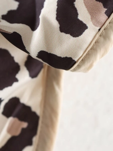 Close-up of leopard print fabric detail with high-quality stitching on sleeve cuff
