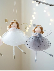Detailed view of white and grey angel dolls with polka dot mesh skirts and plush wings