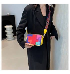 Detailed view of colorful Tetris style crossbody bag with wide geometric pattern strap