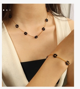 Detail shot of vintage black floral pendant necklace and matching bracelet set