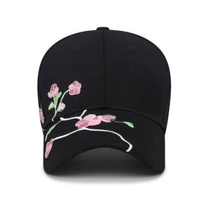 Black cotton baseball cap featuring pink plum blossom embroidery and curved brim