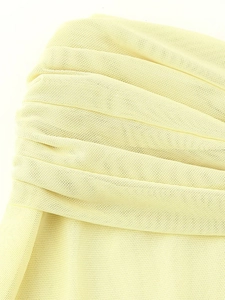 Close-up of pale yellow elastic mesh fabric with elegant horizontal pleated textures