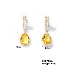Detail of teardrop earrings with gold finish and zircon stones, size 4.8cm by 1.4cm