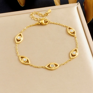 Gold-plated stainless steel evil eye jewelry set with crystals on a champagne box