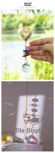 Detail of colorful crystal suncatcher with heart metal piece and faceted glass beads