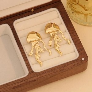 Golden jellyfish stud earrings made of stainless steel displayed in a vintage wooden box