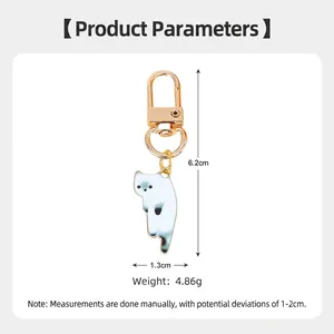 Cute white alloy cat keychain with blue gradient tail and golden D-shaped clasp