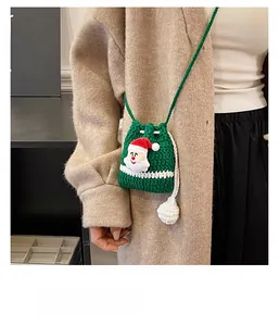 Detail view of handmade Christmas crochet reindeer bag shown on a model outfit