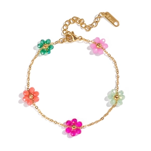 Detail showing gold chain bracelet with colorful beaded flowers and S.STEEL stamp