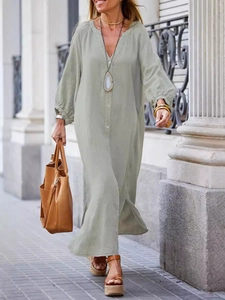 Sage green cotton linen long-sleeve maxi dress with side slits on a street background