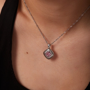 Pink square gemstone necklace with twisted silver chain worn by a female model