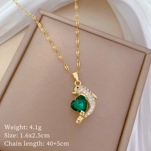 Detailed view of dolphin heart necklace with green gemstone and gold twisted chain