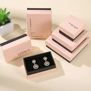 Detail of pink and black drawer style jewelry boxes for earrings and necklaces