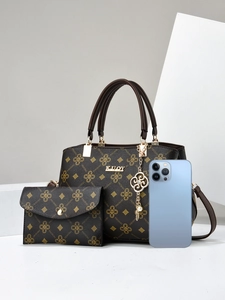 Size comparison of dark brown printed tote bag and wallet set with a smartphone