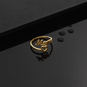 Verstellbarer goldener Ring mit Mom-Schriftzug und Herz auf schwarzer Reflexfläche