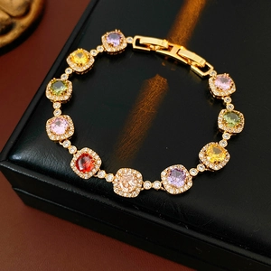 Macro detail of vintage gold bracelet with multi-color square zircon stones on jewelry box