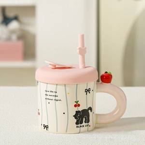 Detail of cute ceramic cat mug with pink lid, straw, and 3D cherry handle ornament
