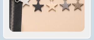 Macro view of universal star-shaped metal zipper pull replacements in five finishes
