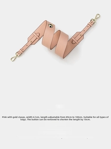 Detail of pink lychee leather shoulder strap with gold clasps and adjustable buckle