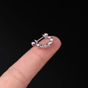 Detailed view of silver screw-back cartilage stud with sparkling cubic zirconia inlay