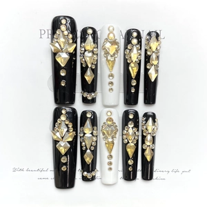 Handmade black and white press-on nail set with amber geometric rhinestones