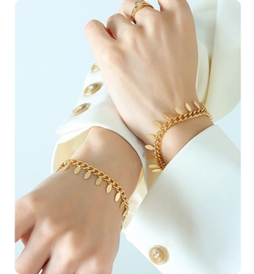 Detail of 18k gold plated chain bracelet with oval leaf pendants and matching ring