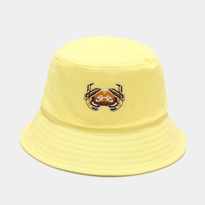 Close-up of yellow bucket hat with detailed crab embroidery and reinforced stitching
