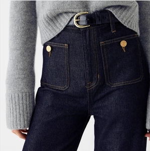 High-waisted dark blue wide-leg denim jeans with dual front pockets and metal button detail