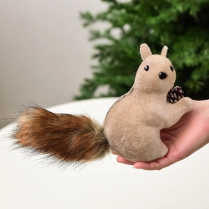 Realistic fuzzy squirrel ornament with brown tail and pine cone for Christmas tree decor